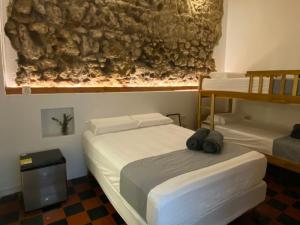 two beds in a room with two bunk beds at Casa Zaguan in Cartagena de Indias