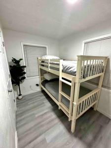 a bedroom with two bunk beds and a window at Modern cozy with pool and big backyard in Tampa