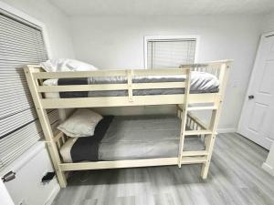 a couple of bunk beds in a room at Modern cozy with pool and big backyard in Tampa +7 photos