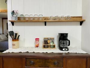 a wooden cabinet with a coffee maker on top of it at Sierra Mountain Lodge - Vacation Rentals - Yosemite in Ahwahnee