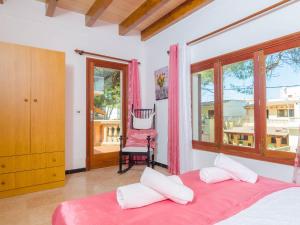 a bedroom with a bed and a chair and a window at Can Pedro Ros - House In S'illot-cala Morlanda Free Wifi in S'Illot