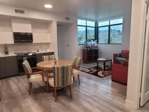 a kitchen and living room with a table and chairs at Dream Escape in the Heart of Los Angeles in Santa Monica