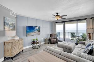 a living room with a couch and a ceiling fan at Windward Pointe 706 in Orange Beach