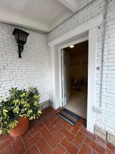 a door to a house with a potted plant at JURAMA in Ciudad Lujan de Cuyo