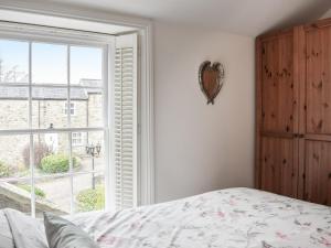 a bedroom with a bed and a large window at The Towers in Witton le Wear