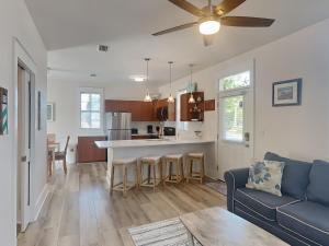 a kitchen and living room with a blue couch at Bungalows at Seagrove #132 - Kruks Fanta Sea in Seagrove Beach