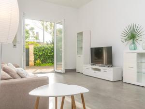a living room with a couch and a tv and a table at Cala Rafalino - House In S'illot-cala Morlanda Free Wifi in S'Illot