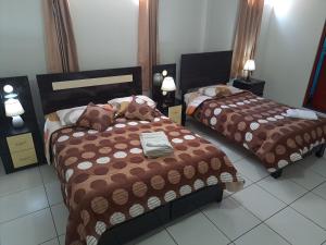 Postel nebo postele na pokoji v ubytování Hotel Residencial C´BASTIAN