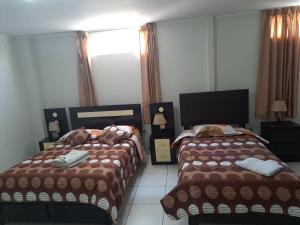 Postel nebo postele na pokoji v ubytování Hotel Residencial C´BASTIAN