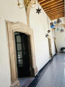 a hallway with a door and a tiled floor at Hotel Boutique Casona los Pavorreales in Durango