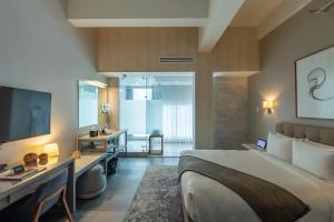 a hotel room with a bed and a television at Stanton House El Paso in El Paso