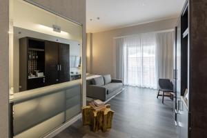 a living room with a couch and a mirror at Stanton House El Paso in El Paso