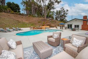 a patio with chairs and a swimming pool at Fallbrook's Finest Hideaway in Fallbrook