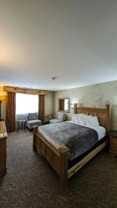 a bedroom with a large bed and a living room at Browns Canyon Inn in Salida