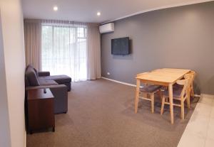 a living room with a table and a couch at The Surrey Hotel in Auckland