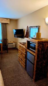 una habitación de hotel con TV y una habitación en Browns Canyon Inn en Salida