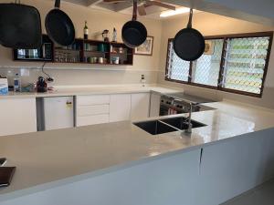 a kitchen with a counter top with pots and pans at Vila Del Mare Beachfront Resort in Port Vila
