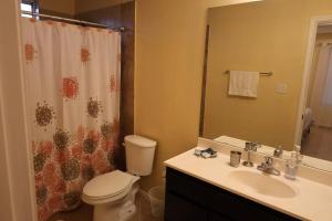 a bathroom with a toilet and a sink and a shower at Mirror, mirror on the wall! in McAllen