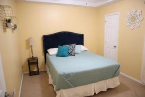 a bedroom with a bed with pillows on it at Mirror, mirror on the wall! in McAllen