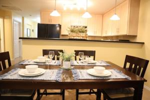 a dining room with a table with chairs and a kitchen at Mirror, mirror on the wall! in McAllen