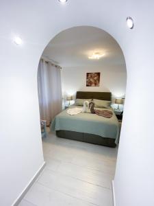 a bedroom with a bed and an archway at Pigadia Central in Karpathos Town