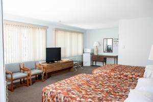 a hotel room with two beds and a flat screen tv at Starlite Motel in Wisconsin Dells