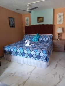 a bedroom with a bed with a stuffed animal on it at Towers by the Beach in Ocho Rios