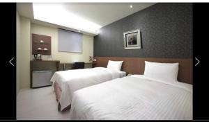 Postel nebo postele na pokoji v ubytování 宜都大飯店 Idol Hotel
