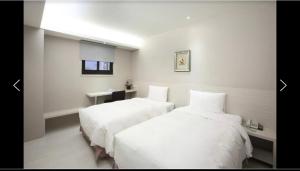 Postel nebo postele na pokoji v ubytování 宜都大飯店 Idol Hotel