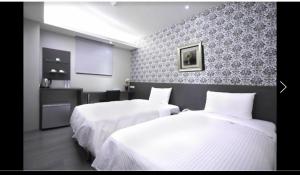Postel nebo postele na pokoji v ubytování 宜都大飯店 Idol Hotel