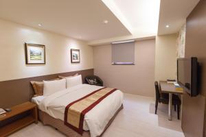 Ένα ή περισσότερα κρεβάτια σε δωμάτιο στο 宜都大飯店 Idol Hotel