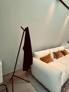 a bedroom with a white bed and a lamp at TRIGON HOUSE HOTEL KOFU in Kofu