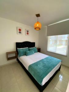 A bed or beds in a room at Apartamento con Piscina en Dosquebradas
