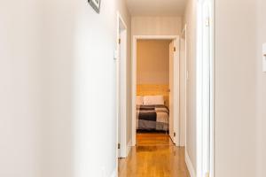 a hallway leading to a bedroom with a bed at Four trees house in Niagara Falls