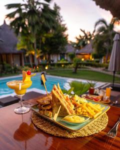 a plate of food on a table next to a drink at Villa Kasadya in Panglao