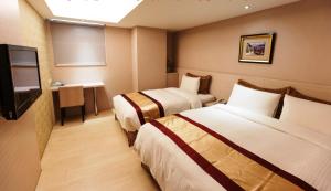 Postel nebo postele na pokoji v ubytování 宜都大飯店 Idol Hotel