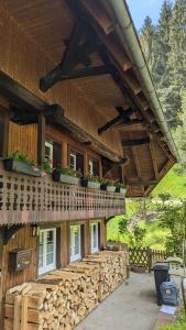 a wooden house with a balcony with plants on it at Ferienwohnung im Historischen Schwarzwaldhaus in Wieden