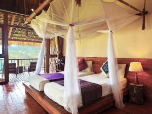 a bedroom with a bed with a canopy at PU LUONG BOUTIQUE GARDEN in Pu Luong +77 photos