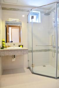 a bathroom with a shower and a sink at Richico Apartments And Hotel in Da Nang