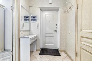 a bathroom with a sink and a white door at Апартаменты возле ЭКСПО in Astana +27 photos
