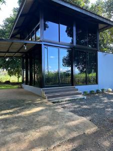 a building with large glass windows and a porch at Hygge Home 