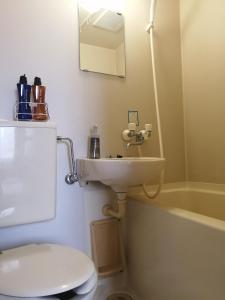 a bathroom with a sink and a toilet and a tub at Hotel Nomad - Vacation STAY 73941v in Hitachi