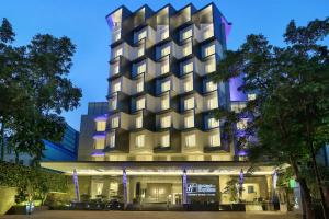 a rendering of a hotel building at night at Holiday Inn Express Jakarta Wahid Hasyim, an IHG Hotel in Jakarta