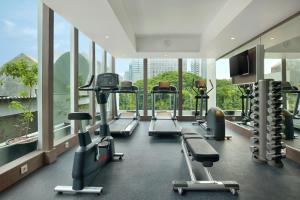 a gym with treadmills and machines in a building at Holiday Inn Express Jakarta Wahid Hasyim, an IHG Hotel in Jakarta