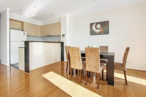 a kitchen and dining room with a table and chairs at 3 BR 2 Bath 2 Carparks next to Crown Casino in Melbourne