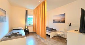 a small room with two beds and a television at -CS24- 4 rooms apartment with rooftop - KA02 in Iserlohn