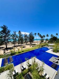an aerial view of a swimming pool and the beach at Roxy Sematan Beach Apartment 2BR or Studio in Sematan