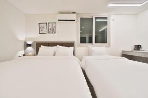 Postel nebo postele na pokoji v ubytování Green B Hotel Busan Seomyeon