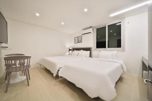 Postel nebo postele na pokoji v ubytování Green B Hotel Busan Seomyeon