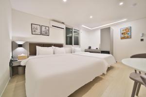 Postel nebo postele na pokoji v ubytování Green B Hotel Busan Seomyeon